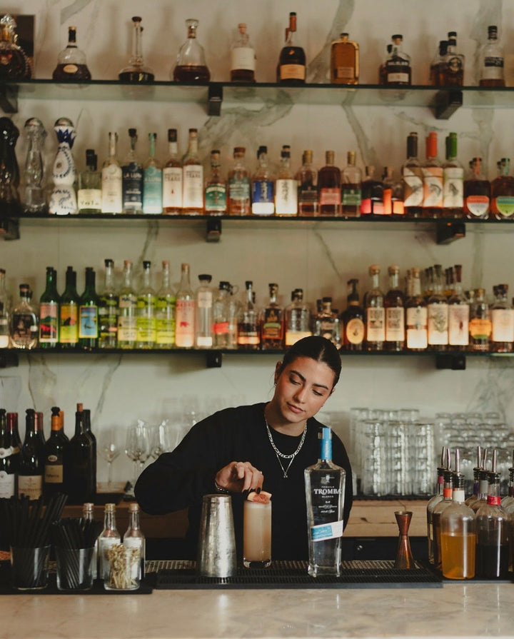 Glass artisan working with a glowing handmade bottle