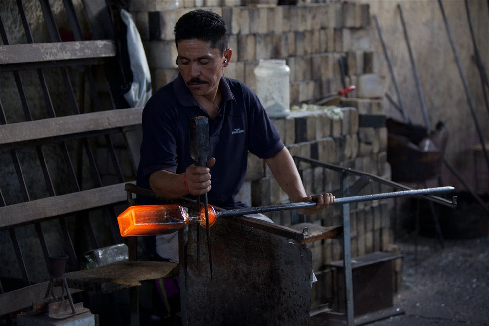 Glass artisan preparing a distinctive Tromba bottle